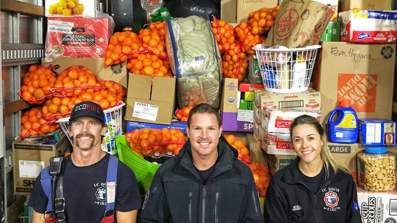 fire fighters in front of donations made for the Camp Fire victims