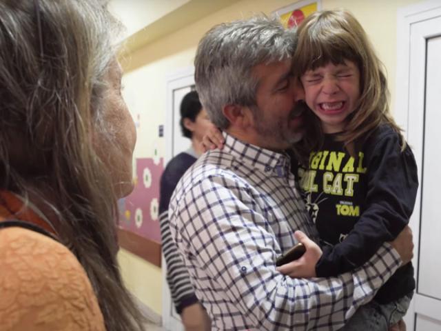 a father hold a crying child in a hospital in Serbia